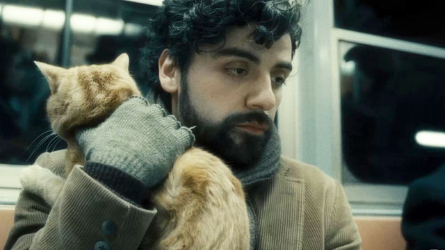 Still from inside llewyn Davis, Oscar Isaac carries an orange cat