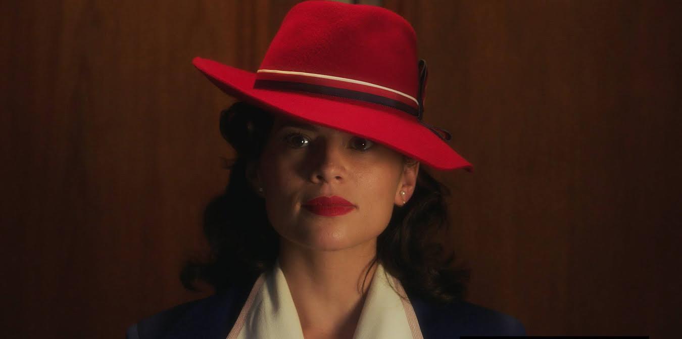 hayley atwell peggy carter red dress Peggy Carter Pub scene hero red crepe dress. This is the breathtaking dress that Agent Peggy Carter is wearing when she makes her dramatic entrance at the pub where Steve Rogers and