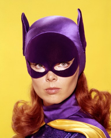 Yvonne Craig, US actress, in costume, in a studio portrait, against a yellow background, issued as publicity for the US television series, 'Batman', circa 1967. The series, featuring DC Comics characters, starred Craig as ''Barbara Gordon/Batgirl'. (Photo by Silver Screen Collection/Getty Images)