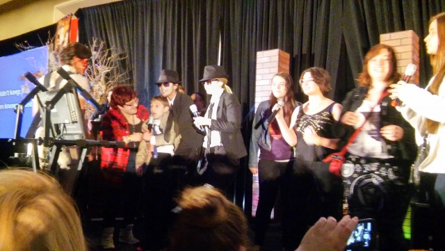 Kim singing karaoke Let it Go with kid in wheelchair