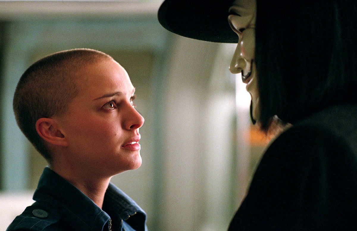 A young white woman talks to a masked person in "V for Vendetta"