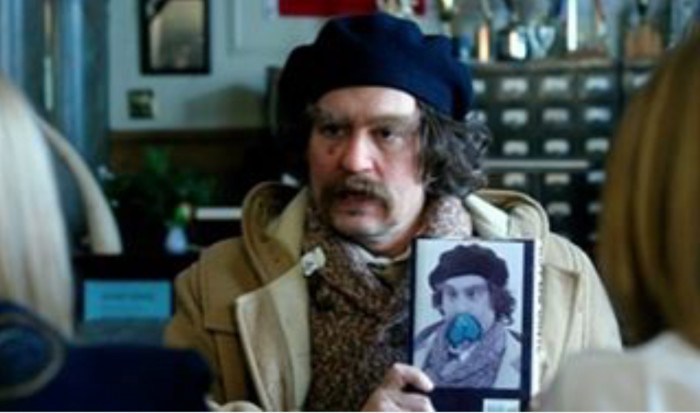 Dude holding a picture of himself with balls on his face. ART.