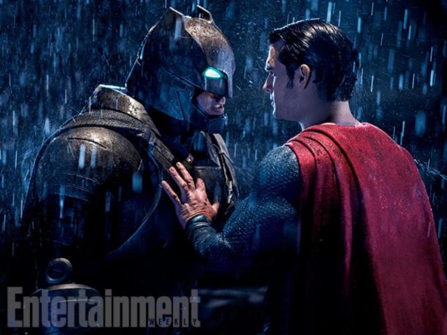Batman and Superman face each other in the rain