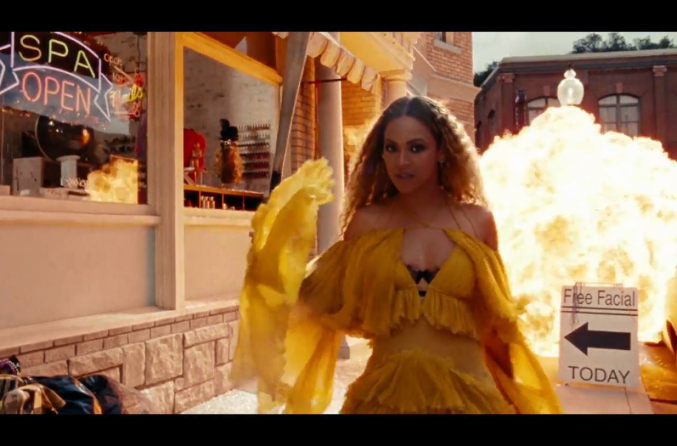 Beyonce walking away from an explosion in the Lemonade video.