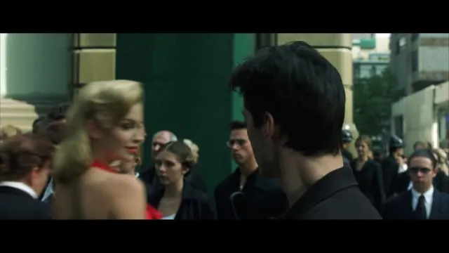 Neo sees the woman in the red dress.