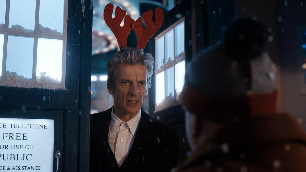 Peter Capaldi's 12th Doctor wearing a reindeer antler headband for Christmas