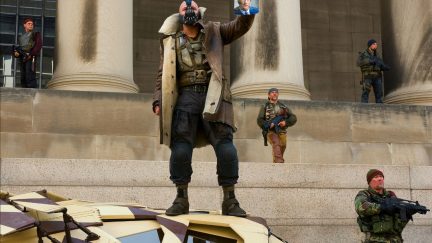 bane from the dark knight rises holding a pic of harvey dent.