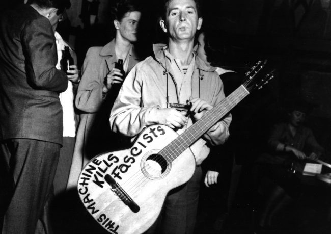 Woody Guthrie and his Fascist-killing guitar ~ 1941.