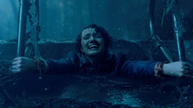 Barb being pulled into an empty pool by the Demogorgon