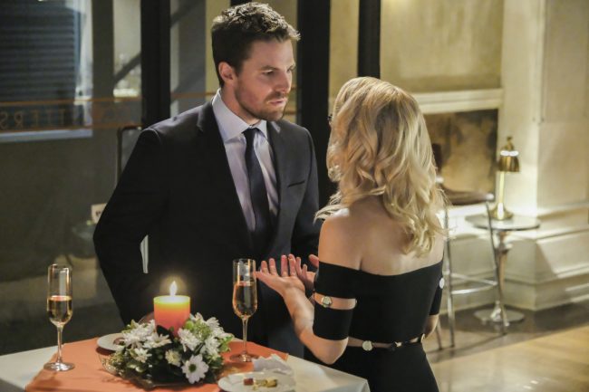 image: Bettina Strauss/The CW Supergirl -- "Crisis on Earth-X, Part 1" -- Pictured (L-R): Stephen Amell as Oliver Queen and Emily Bett Rickards as Felicity Smoak -- © 2017 The CW Network, LLC. All Rights Reserved