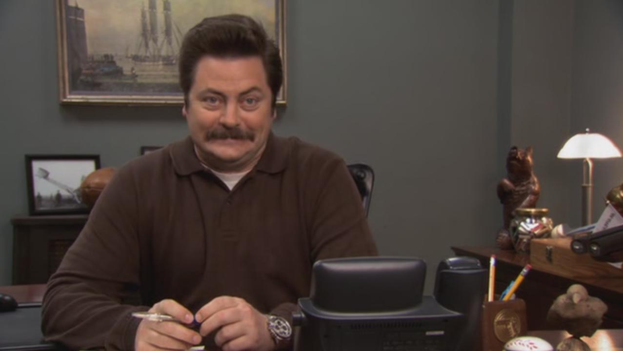 Ron Swanson slight smile and eyebrow raise in Parks and Recreation