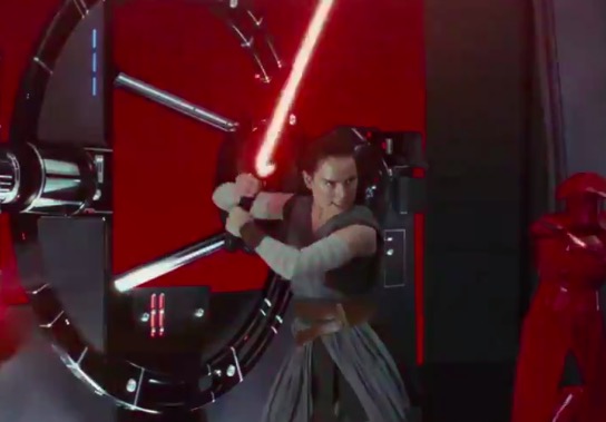 Rey with Kylo's lightsaber in Star Wars: The Last Jedi