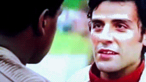 Poe Dameron bites his lip while talking to Finn