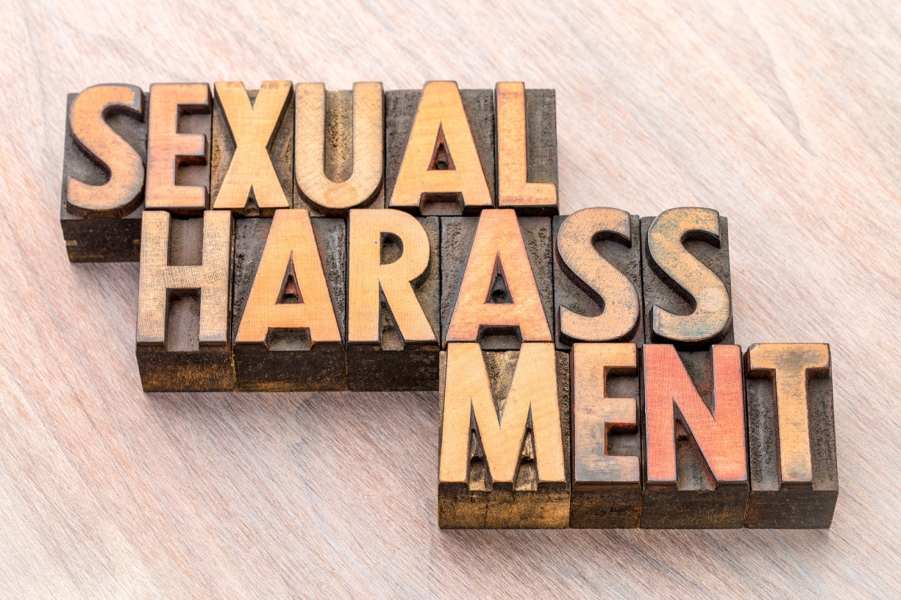 Shutterstock image of the words sexual harassment in wood-block letters