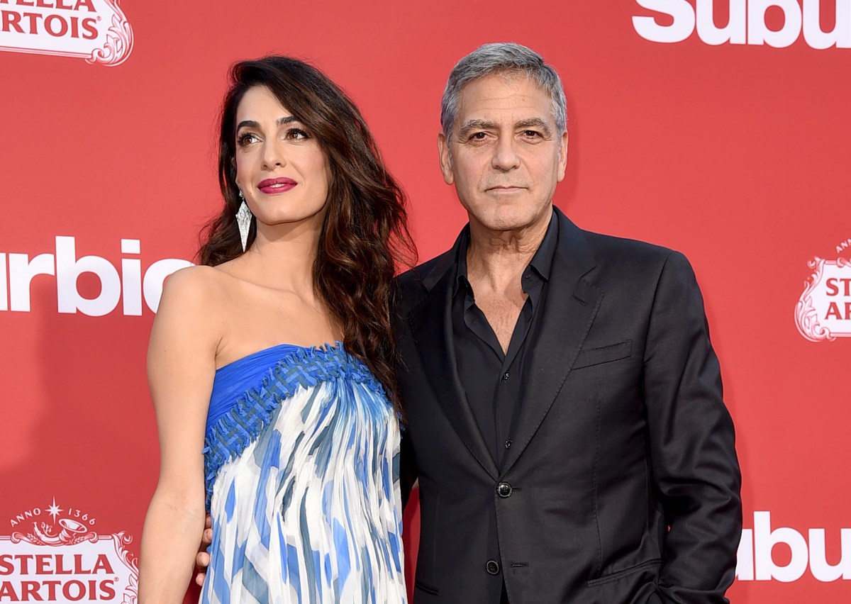 image: Kevin Winter/Getty Images LOS ANGELES, CA - OCTOBER 22: Executive producer George Clooney (R) and his wife Amal Clooney arrive at the premiere of Paramount Pictures' "Suburbicon" at the Village Theatre on October 22, 2017 in Los Angeles, California. 