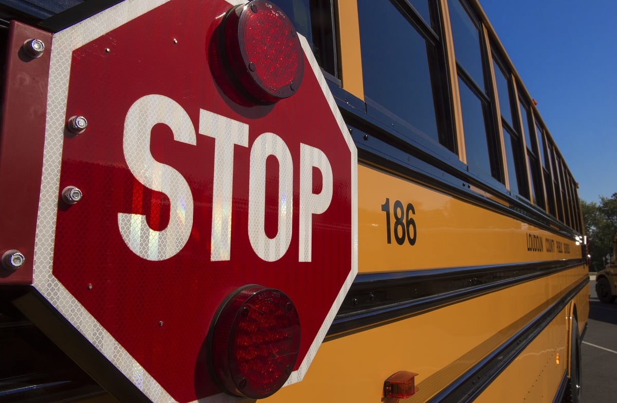 A school bus with a stop sign (Photo credit should read PAUL J. RICHARDS/AFP/Getty Images)