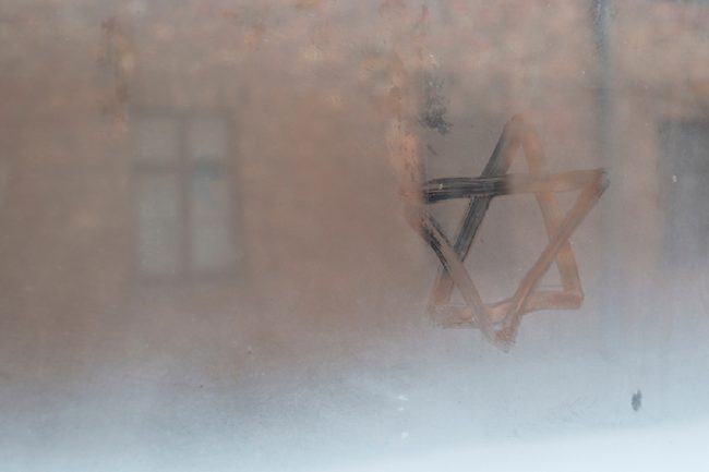 image: Brais Seara/Shutterstock Auschwitz, Lesser Poland / Poland - Feb 04 2018: Auschwitz Birkenau, Nazi concentration and extermination camp. Star of David painted by a visitor in the condensation of a window. Jewish