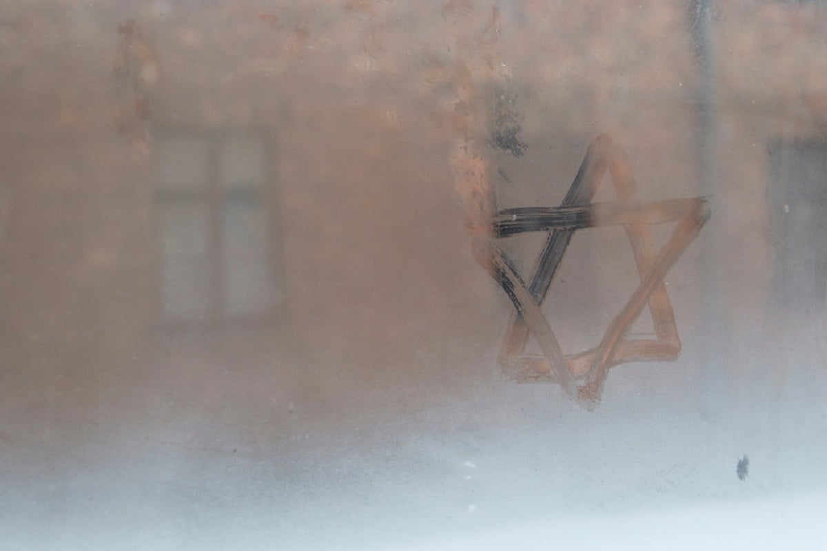 Auschwitz, Lesser Poland / Poland - Feb 04 2018: Auschwitz Birkenau, Nazi concentration and extermination camp. Star of David painted by a visitor in the condensation of a window. Jewish