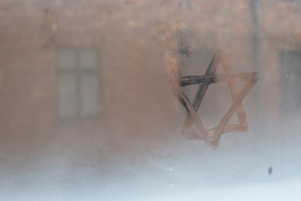 Auschwitz, Lesser Poland / Poland - Feb 04 2018: Auschwitz Birkenau, Nazi concentration and extermination camp. Star of David painted by a visitor in the condensation of a window. Jewish