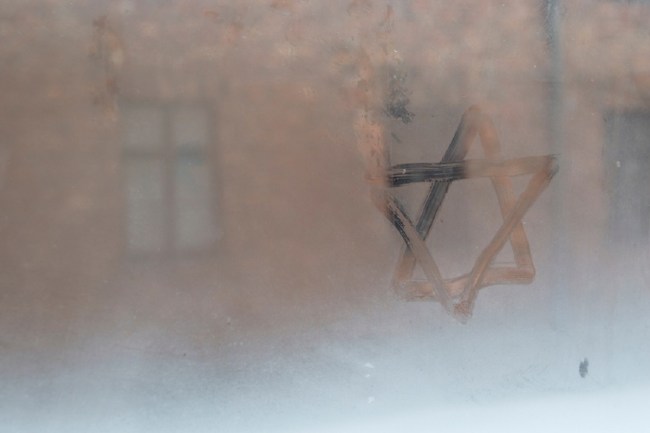 image: Brais Seara/Shutterstock Auschwitz, Lesser Poland / Poland - Feb 04 2018: Auschwitz Birkenau, Nazi concentration and extermination camp. Star of David painted by a visitor in the condensation of a window. Jewish