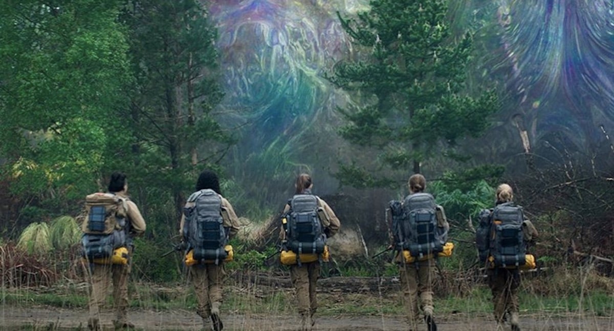 Women in jumpsuits approach the mysterious area known as "the shimmer" in 'Annihilation'