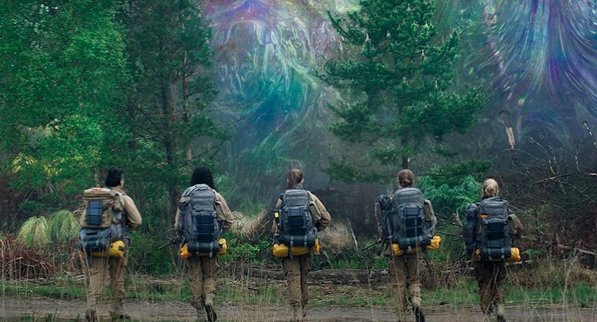 Women in jumpsuits approach the mysterious area known as "the shimmer" in 'Annihilation'