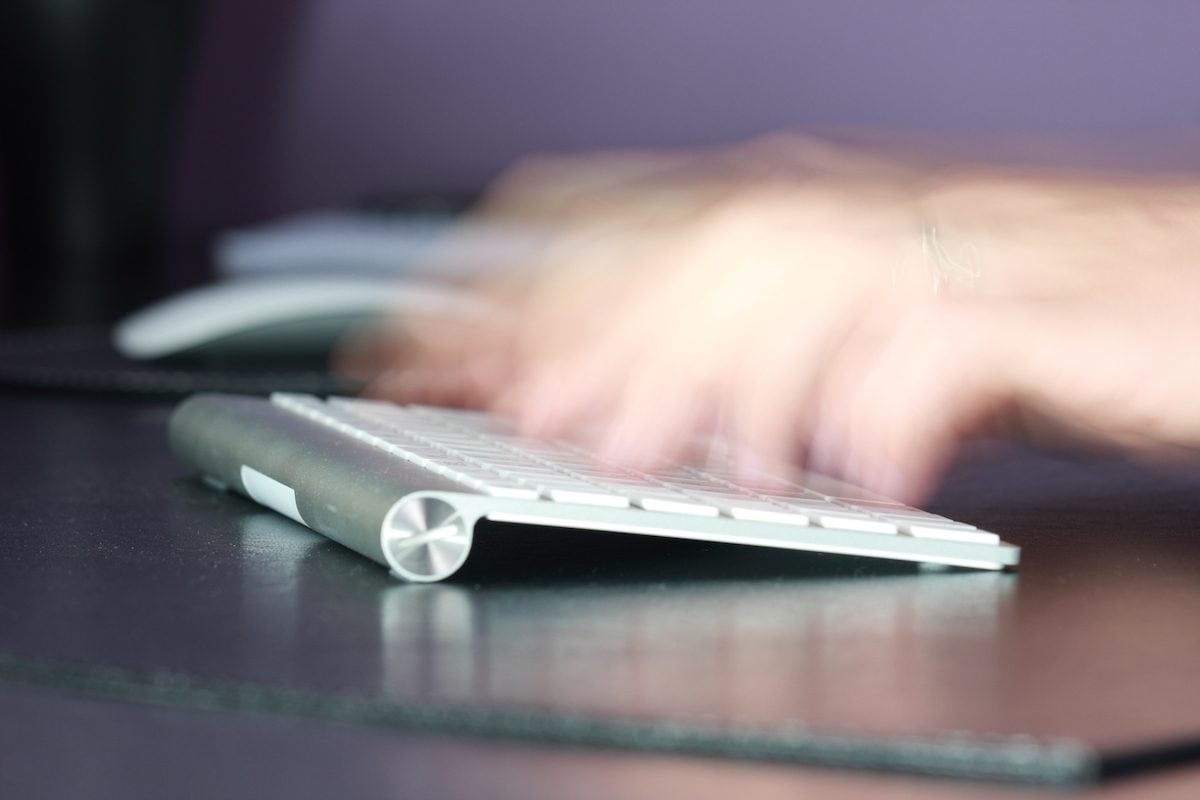 hands typing on keyboard