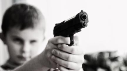 Young boy holding gun.