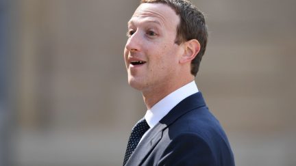 Mark Zuckerberg smiles looking into the distance
