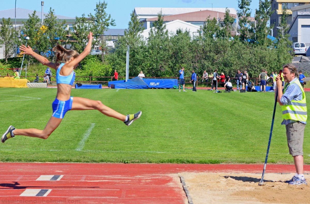 Woman doing the long-jump during track and field event