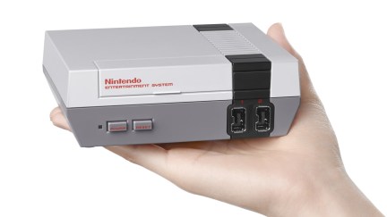 nes classic edition in the palm of a hand