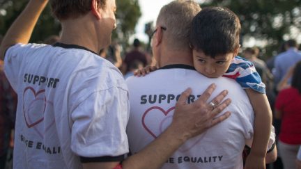 WEST HOLLYWOOD, CA - JUNE 26: Mark Beckfold and Steve Ledoux (R) , who are married, hold their foster son at a celebration of the Supreme Court ruling on same-sex marriage on June 26, 2015 in West Hollywood, California. The Supreme Court ruled today that same-sex couples have a constitutional right to marry nationwide without regard to their state's laws. (Photo by David McNew/Getty Images)