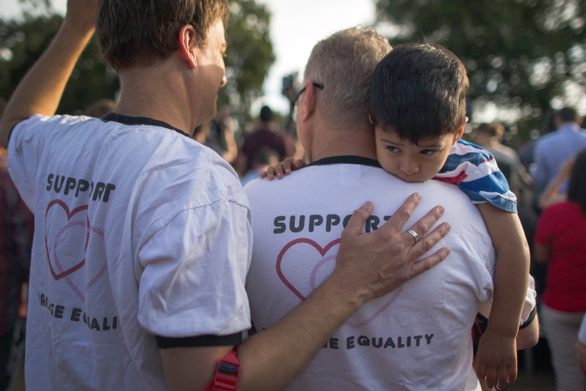 WEST HOLLYWOOD, CA - JUNE 26: Mark Beckfold and Steve Ledoux (R) , who are married, hold their foster son at a celebration of the Supreme Court ruling on same-sex marriage on June 26, 2015 in West Hollywood, California. The Supreme Court ruled today that same-sex couples have a constitutional right to marry nationwide without regard to their state's laws. (Photo by David McNew/Getty Images)