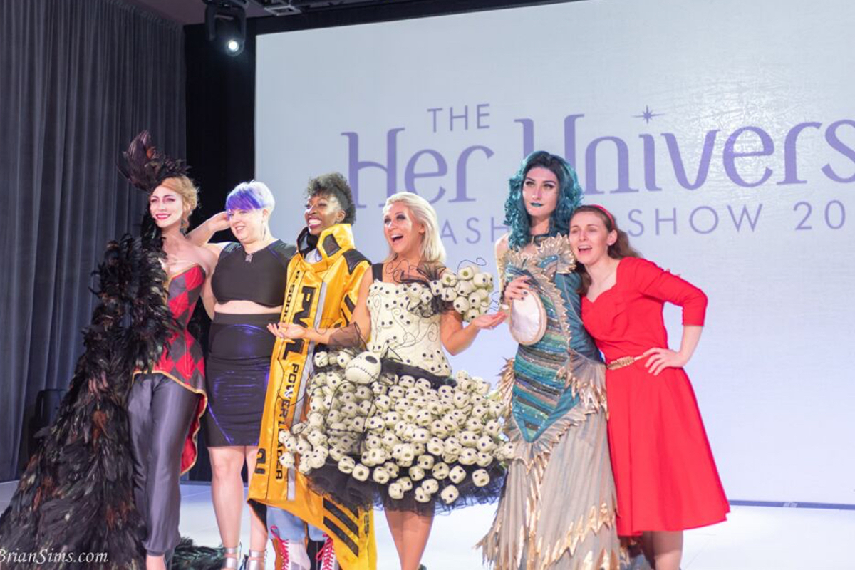 The winners of the 2018 Her Universe Fashion Show pose with Ashley Eckstein in this photo by Brian Sims
