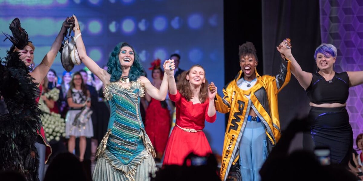 The winners of the Her Universe Fashion Show celebrate their victory in a moment captured by Brian Sims