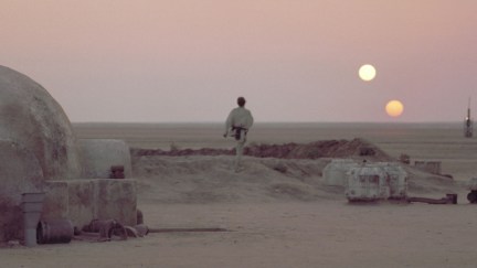 Luke Skywalker walks across Tatooine as the twin suns set