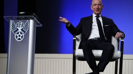 Jeff Bezons sitting on a stage.