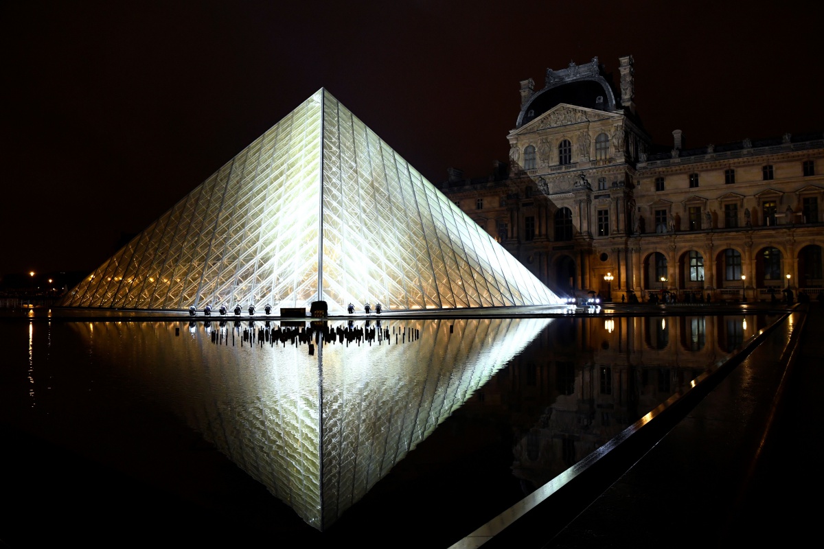 TOPSHOT - The Louvre Pyramid is illuminated in the night, prior to the Louis Vuitton Spring-Summer 2019 Ready-to-Wear collection fashion show in Paris, on October 2, 2018. (Photo by Bertrand GUAY / AFP) (Photo credit should read BERTRAND GUAY/AFP/Getty Images)