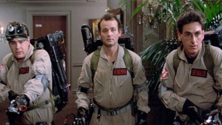 Three of the original Ghostbusters all suited up hunting ghosts.