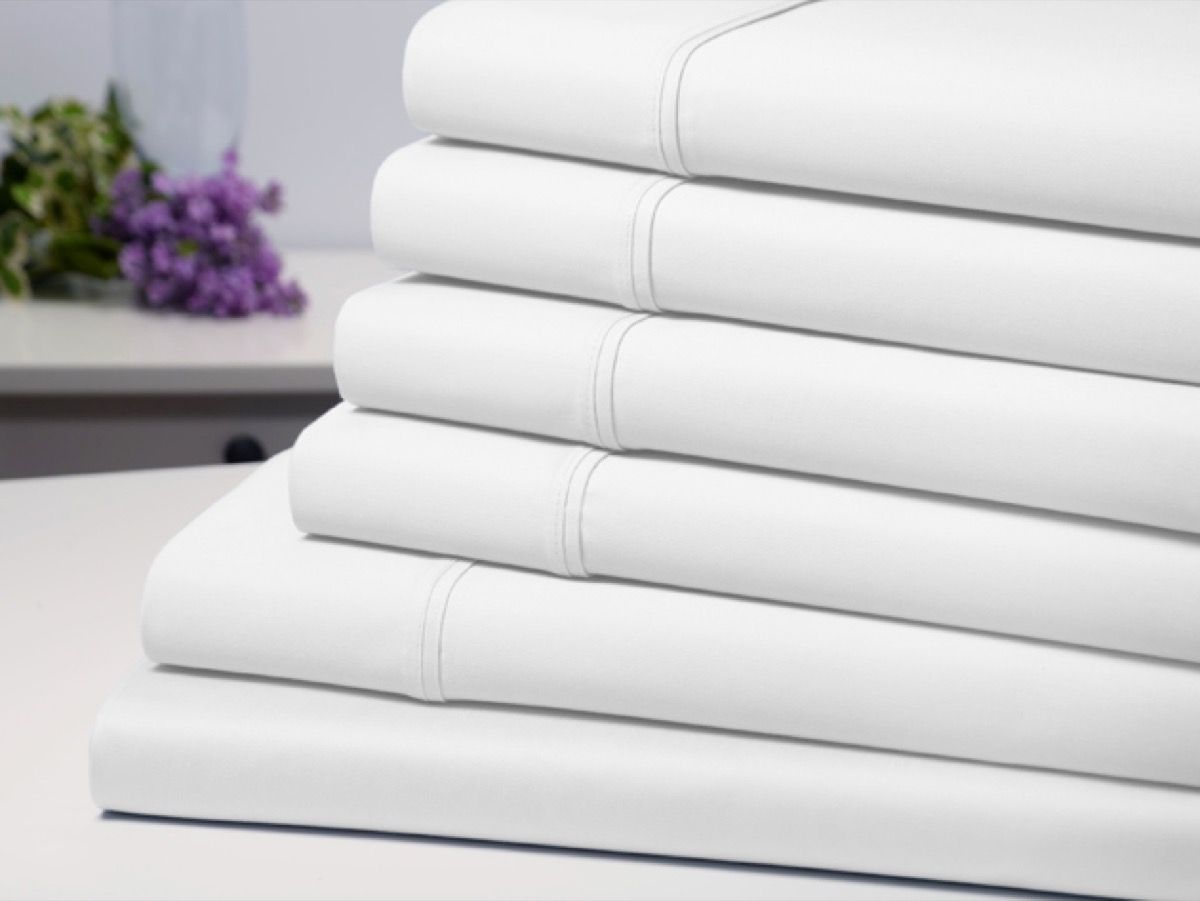A stack of folded white sheets.