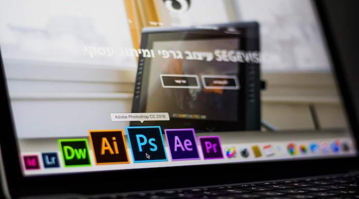 Adobe creative applications on a laptop screen.
