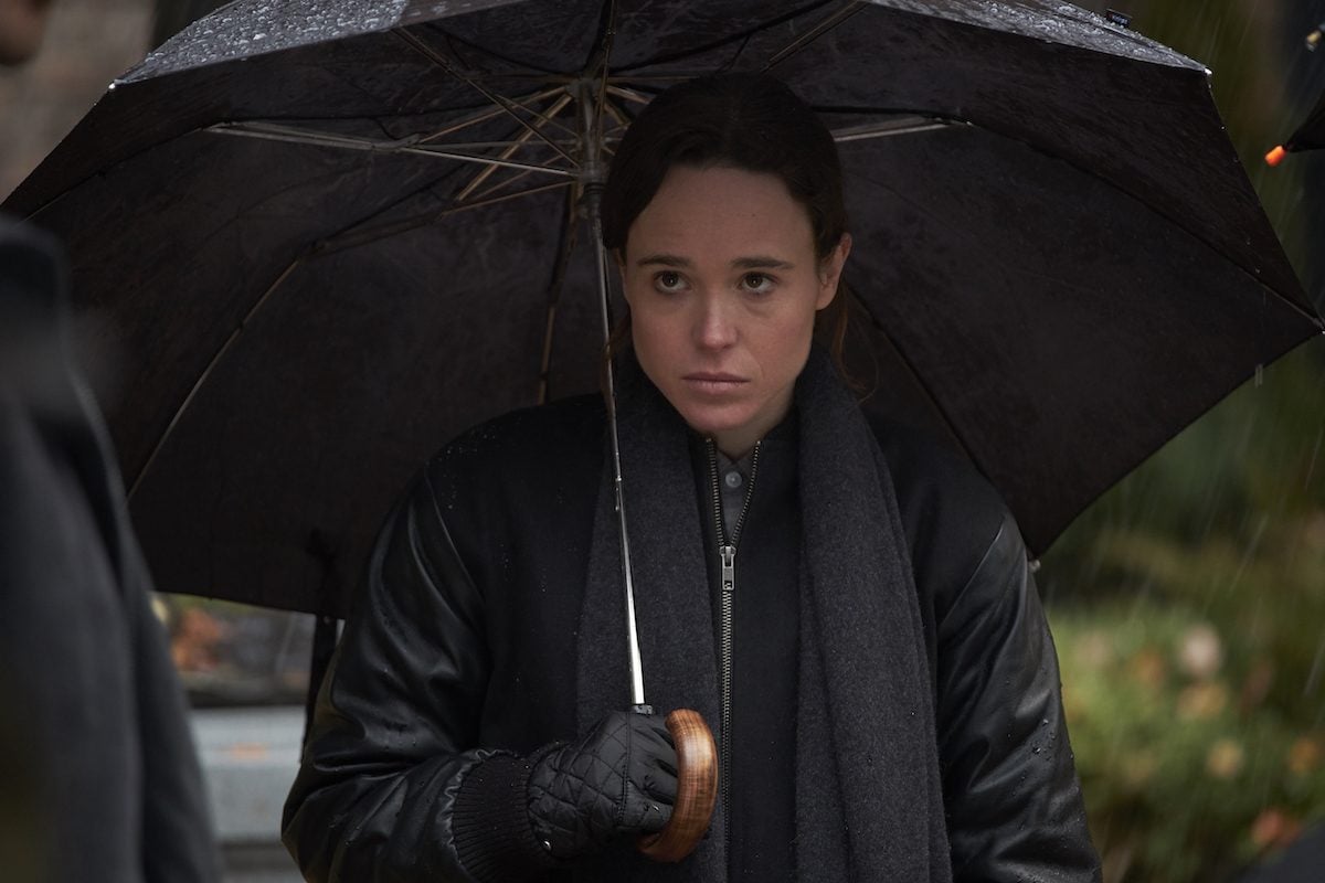 Ellen Page holding an umbrella and looking glum in Netflix's Umbrella Academy.