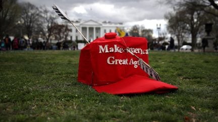 An oversized replica of a 'Make America Great Again' hat sits on the grass across from the White House during a demonstration against the Dakota Access Pipeline