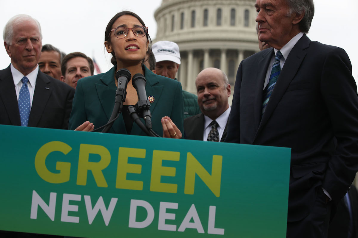 U.S. Rep. Alexandria Ocasio-Cortez (D-NY) speaks as Sen. Ed Markey (D-MA) (R) and other Congressional Democrats listen during a news conference in front of the U.S. Capitol