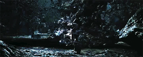 Bruce Wayne aka Christian Bale is surrounded by bats in Batman Begins.