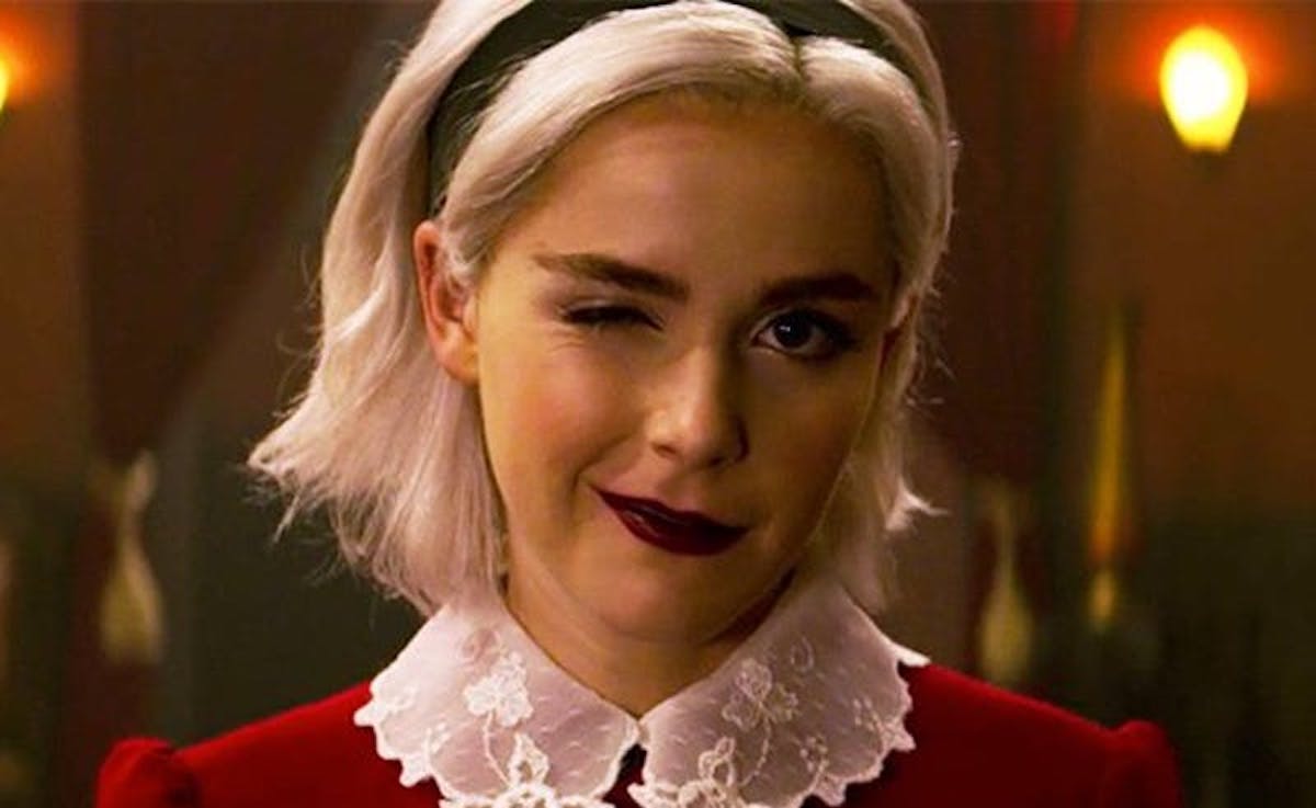 Kiernan Shipka as Sabrina winks at the camera in Chilling Adventures of Sabrina.