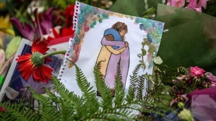 A picture is left among flowers and tributes near Al Noor mosque on March 18, 2019 in Christchurch, New Zealand