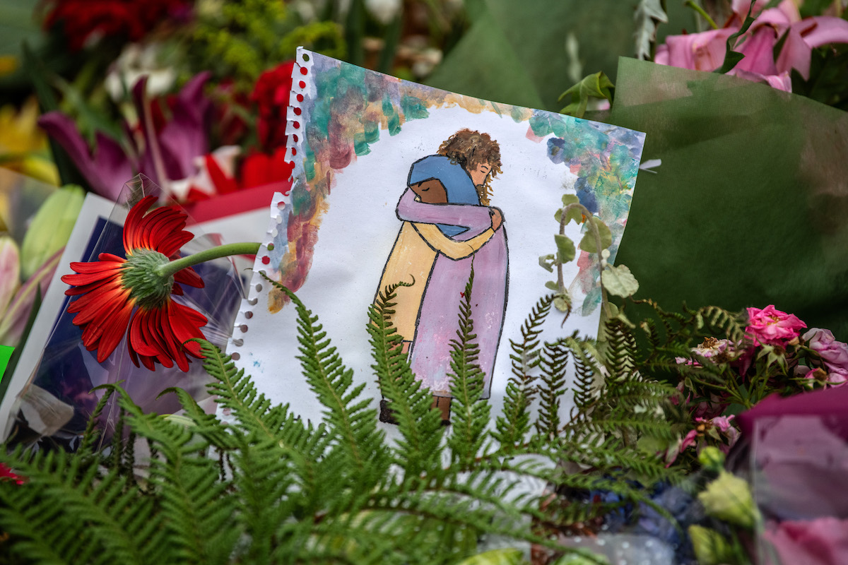 A picture is left among flowers and tributes near Al Noor mosque on March 18, 2019 in Christchurch, New Zealand