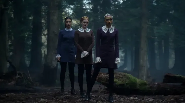 The weird sisters standing in the woods in Chilling Adventures of Sabrina.