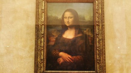 The famous Leonardo Da Vinci painting ' The Mona Lisa' is seen on display in the Grande Galerie of the Louvre museum on August 24, 2005 in Paris, France. Dan Brown is the author of numerous bestsellers, including Digital Fortress, Angels and Demons, and Deception Point. His acclaimed novel 'The Da Vinci Code'has become one of the most widely read books of all time. (Photo by Pascal Le Segretain/Getty Images)